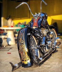 a custom painted motorcycle parked in a garage