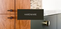 there is a sign that says hardware on the front of a cabinet in a room