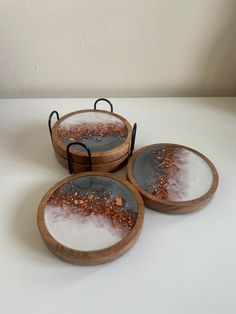 three wooden trays with different designs on them