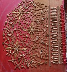 two pieces of red cloth with gold embroidered designs on them, sitting next to each other