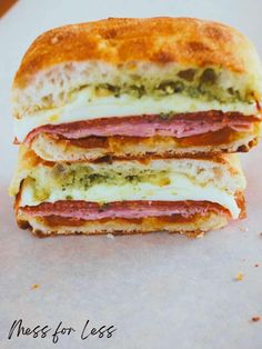 two sandwiches stacked on top of each other with meat and cheese in between the sandwich halves