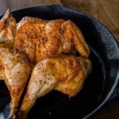 a close up of a chicken in a pan on a table