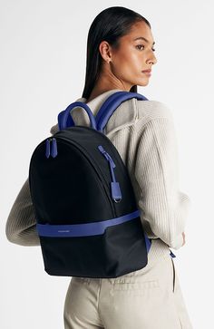 Our sleekest carryall, now crafted from a revolutionary water, stain and knock-resistant fabric. The Resilon Nylon Backpack, a 100% recycled water-resistant yarn produced from discarded fishing nets, is coupled with full-grain leather accents to create an ultra-durable unisex bag featuring six external zip-and-slip pockets and four more inside. Evenly distributing weight through densely padded straps and backing, our original icon is reimagined with enhanced security through an added recessed fr Blue Nylon Backpack, Versatile Blue Nylon Backpack, Blue Nylon Everyday Backpack, Everyday Blue Nylon Backpack, Modern Nylon Softback Backpack, Waterproof Nylon Backpack For On-the-go, Blue Nylon Backpack For Commuting, Navy Nylon Backpack, Blue Backpack With Adjustable Strap For Commuting