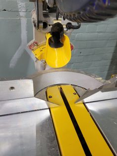 a machine that is cutting something yellow on it