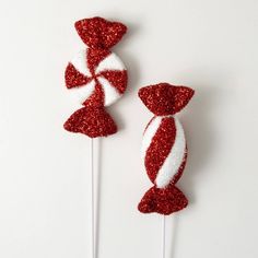 two red and white candy lollipops sitting on top of each other