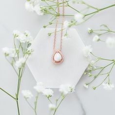 The meaning of "Halo Au Lait" is "Halo with Milk" in French, reflecting the essence of the necklace. The drop-shaped stone is expertly crafted to resemble a drop of milk, capturing the sacrifice of motherhood. Its unique shape also adds deep symbolism to the necklace, reminding us of the life-giving nature of breastmilk. White Teardrop Jewelry As A Gift For Her, Delicate White Pear-shaped Necklace, Pear-shaped Pearl Pendant Necklace As Gift, Spiritual Teardrop Wedding Necklaces, Rose Gold Teardrop Necklace With Pearl Pendant, Spiritual White Birthstone Necklaces, Spiritual White Necklace As Gift For Her, Spiritual Teardrop Necklace For Wedding, Delicate White Oval Pendant Necklace