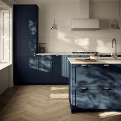 a kitchen with blue cabinets and wooden floors