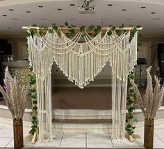 a decorated stage with white flowers and greenery