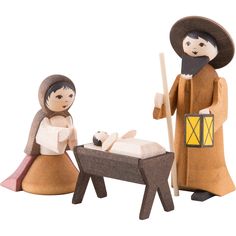 two wooden figurines are shown with a baby in a crib and an adult standing next to it