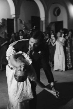 a man and woman dance in front of a crowd