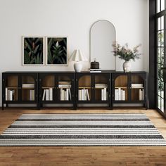 a living room with two bookshelves and an area rug in front of it