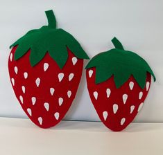 two felt strawberries sitting on top of each other