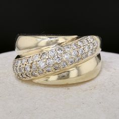 two gold rings with white diamonds on them