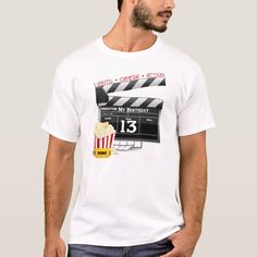 a man wearing a white t - shirt with a movie claper and popcorn on it