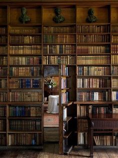 there is a book shelf with many books on it and the words have a secret room behind it