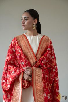 "Nothing speaks to the splendour and opulence of Banarasi handloom better than this pure Katan silk\u00a0Odhni. It features a ravishing kadhua jaal, exquisitely crafted in gold and silver zari with accents of meenakari on a\u00a0breathtaking silken bed.\n\u00a0\n\n\n Color\u00a0- A classic shade of\u00a0Red\n\n Technique\u00a0- Classic handwoven Banarasi art passed down through generations and an enduring Kadwa weave. The elaborate and laborious Kadwa (Kadhua) technique involves hand-weaving each motif separately. It takes longer on the handloom, but makes a more robust pattern which stands out on the fabric.\u00a0\n\n Fabric\u00a0- Soft as butter, pure Katan silk\n\n Speciality\u00a0- Luxury is in the details of this handwoven masterpiece with a rich and intricate Meenakari kadhua floral Luxury Katan Silk Dupatta Fabric, Luxury Katan Silk Traditional Wear For Ceremonies, Luxury Banarasi Silk Sets With Zari Weaving, Cheap Festive Katan Silk Dupatta, Luxury Handloom Party Dupatta, Luxury Traditional Katan Silk Sets, Luxury Katan Silk Dupatta With Printed Border, Dupatta Draping Styles, Dupatta Draping