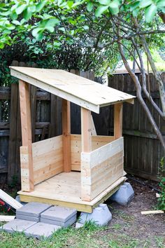 a small wooden shed sitting in the middle of a yard