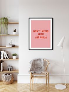 a pink poster with the words i love you on it in a white living room