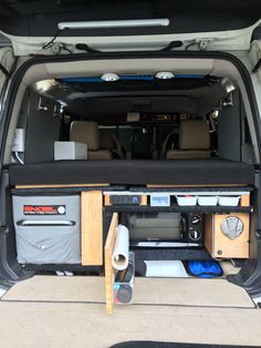 the back end of a van with its cargo compartment open and various items in it