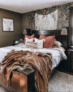 a bedroom with a large bed covered in blankets and pillows