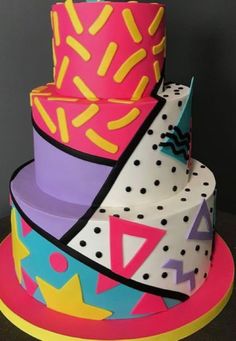 a multi - tiered cake is decorated with bright colors and designs on the side