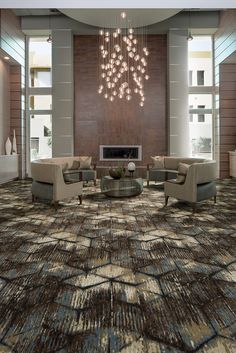 a living room with couches, chairs and a chandelier hanging from the ceiling