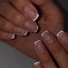 a woman's hands with pink and white nail polishes on their nails,