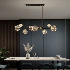 an elegant dining room with modern lighting fixtures