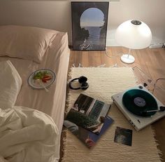 a bed room with a record player and a plate of food on top of it