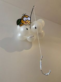 some balloons are hanging in the shape of cartoon characters