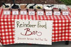 a red and white checkered table cloth with food on it that says reindeer food bar