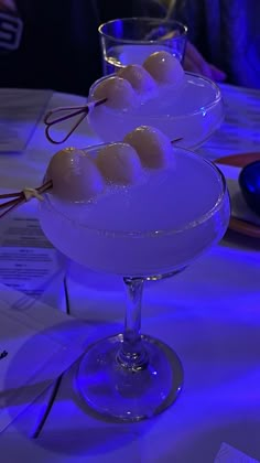 two glasses filled with ice cream on top of a table