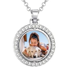 a woman and her dog are shown in the center of a pendant with diamonds on it