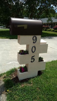 a mailbox that has flowers growing out of it