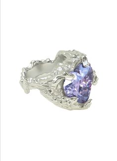 The Molten Lavender Heart Stone Ring is meticulously handcrafted in the heart of New York. The ring boasts a stunning colored stone that mesmerizes and comes to life when kissed by the light. Crafted with utmost precision, this ring is fashioned from premium 925 Sterling Silver, ensuring exceptional quality and durability. With its origins deeply rooted in the streets of New York, this ring reflects the city's energy. The artisans who delicately mold and shape each piece pour their passion into Blue Heart Ring, 90s Jewelry, Pear Cut Ring, Lavender Heart, Heart Stone, Colored Stones, Colored Stone, Shiny Things, Delicate Jewelry