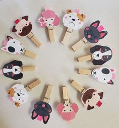 a circle made up of wooden pegs with different animal faces on them, all in various shapes and sizes