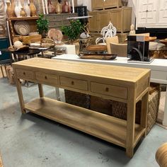 a wooden table with baskets on it in a store