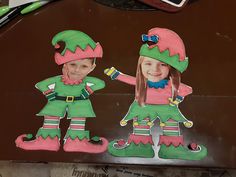 two children's cut outs are shown in the shape of elfs on a table