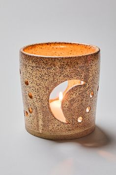 a ceramic candle holder with a crescent design