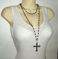 This is one of those stunning pieces that will become an instant favorite of yours (and the instant envy of your friends Featuring black hematite beads that have a magical sparkle and depth of their own, this beaded double chain cross necklace has a gorgeous filigree cross hanging on the end of the longer chain. Lengths of the chain can be adjusted, but currently measure 17 inches (shorter chain) and 35 inches (longer chain). Long Cross Necklace, Black Rosary, Cross Chain Necklace, Black Cross Necklace, Necklace Outfit, Double Chain Necklace, Diy Jewelry Projects, Beaded Cross, Original Characters