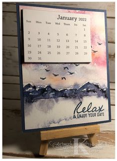 a calendar card with birds flying around it