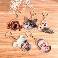 four different key chains with pictures of cats and dogs on them, one has a dog's head in the middle