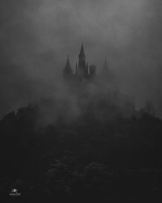 a castle in the fog on a hill