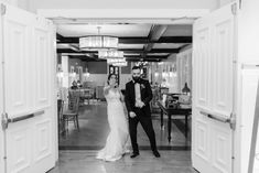 a bride and groom are walking through an open door to the reception room at their wedding