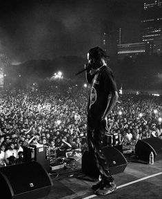 a man standing on top of a stage in front of a crowd