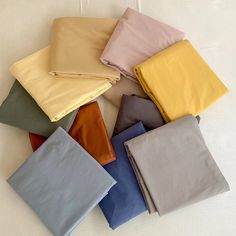 various colors of sheets laid out on top of each other with one folded in the middle