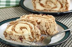 two plates with desserts on them sitting on a checkered table cloth, one has a fork in it