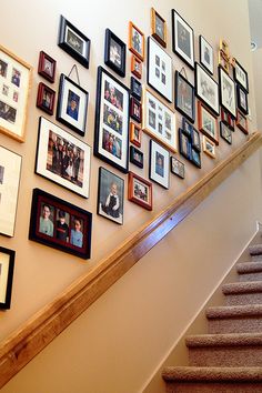 a staircase with many framed pictures on the wall