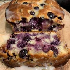 blueberry bread is cut in half on a cutting board