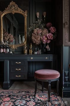 a room with a vanity, mirror and flowers on the table